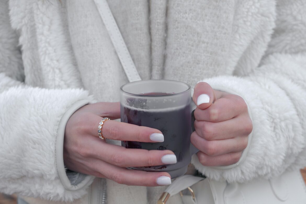 Holding Coffee, wearing jewelry