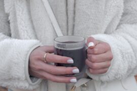 Holding Coffee, wearing jewelry