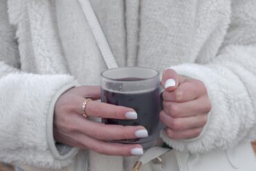 Holding Coffee, wearing jewelry